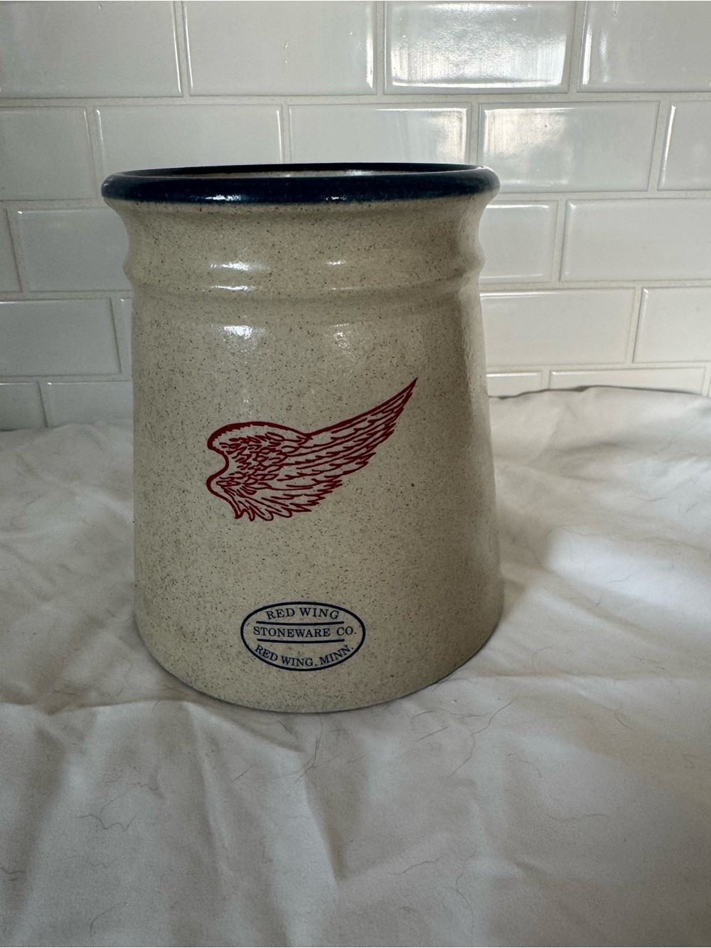Red Wing Pottery Stoneware Utensil Crock with Red Wing Logo and Blue Rim.